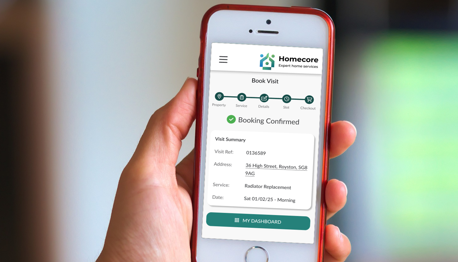 Photo of a hand holding a mobile phone, with the Homecore system on screen