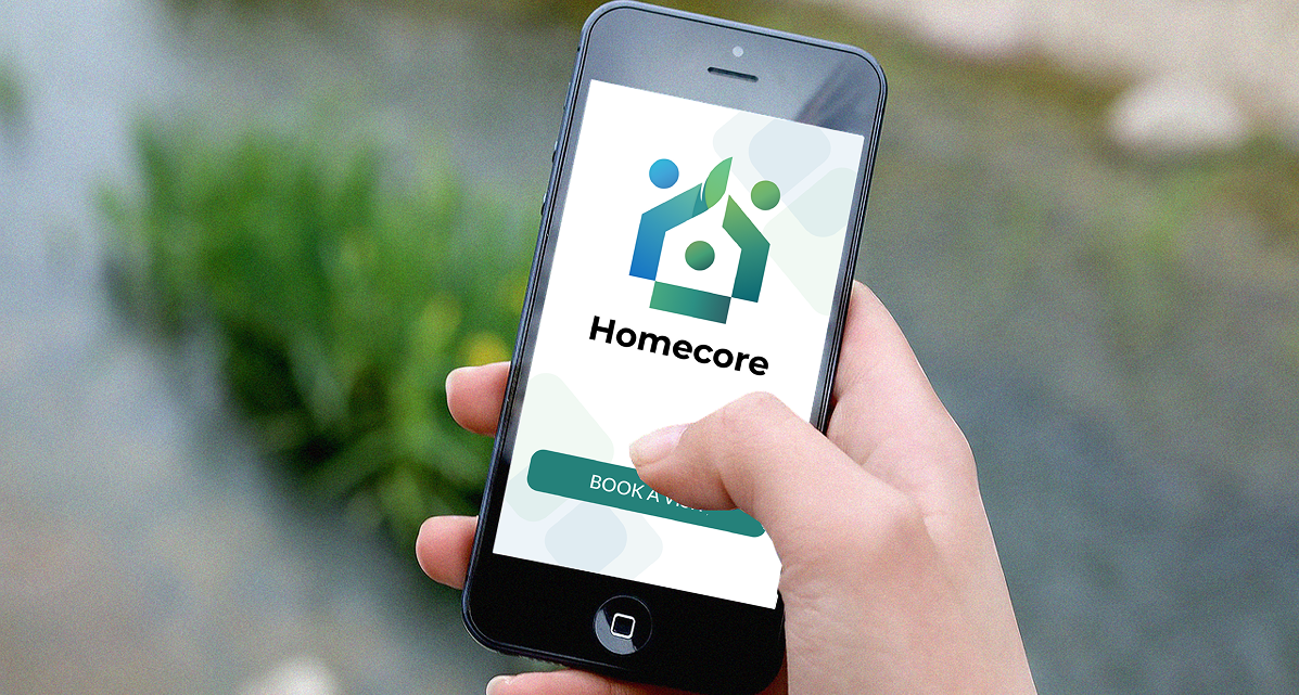 Photo of a hand holding a mobile phone, with the Homecore system on screen