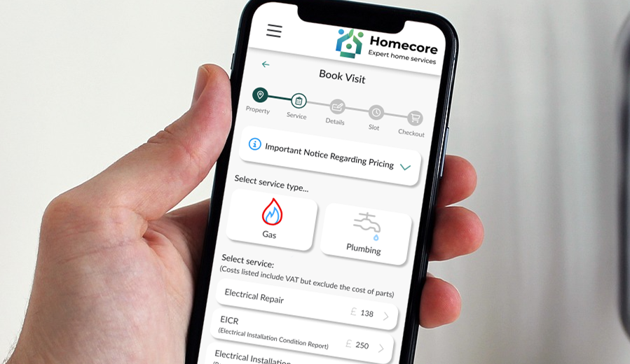 Photo of a hand holding a mobile phone, with the Homecore system on screen