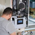 Photo of an engineer working on a boiler